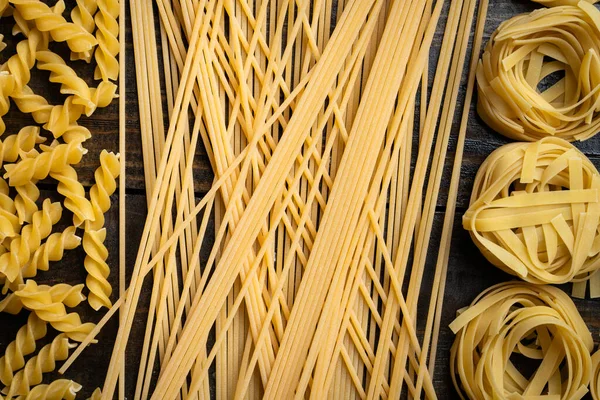 Pasta Shapes Spaghetti Fusilli Tagliatelle Italian Cuisine Ingredients Wooden Background — Stock Photo, Image