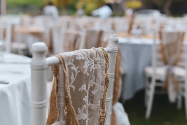 Table or chair dressing. Wedding rustic table or chair dressing outdoors for wedding party. Selective Focus.