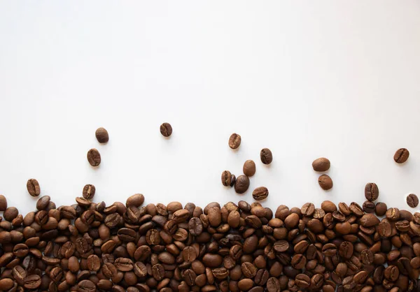 Rain of coffee beans. Group of coffee beans like rain with copy space isolated on white background.