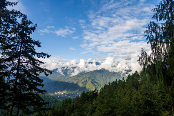Beautiful view of a valley with trees and mountains in Bhutan, scenic panorama mountain summer landscape in Asia.