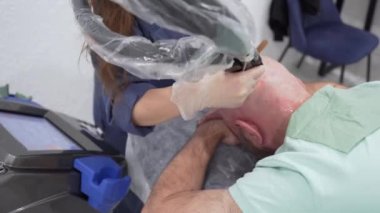 Close up bearded bold man head epilation laser hair removal procedure treatment, unpainful procedure, beauty concept, alexandrite laser