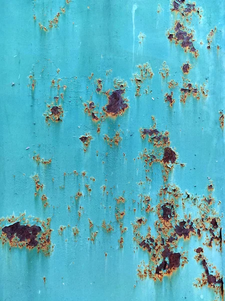 Corroded metal background. Rusted white painted metal wall. Rusty metal background with streaks of rust. Rust stains. The metal surface rusted spots. Rusty corrosion.