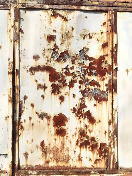 Rusted colorful painted metal wall. Rusty metal background with streaks of rust. Corroded metal background. Rust stains. The metal surface rusted spots. Rusty corrosion.