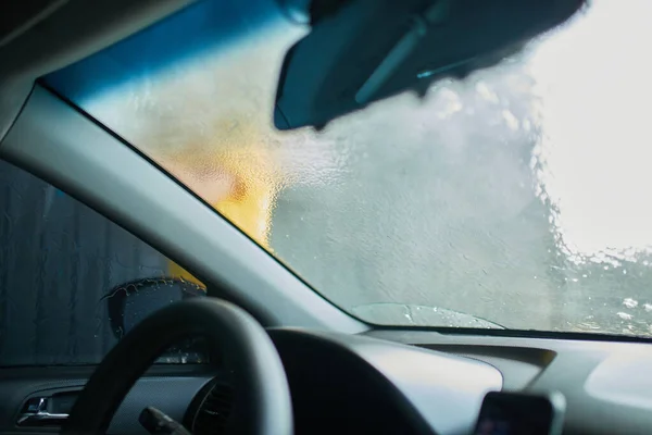 stock image Man washing his car, using on self service washing, contactless high pressure water jet