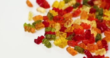 Rotation tasty jelly bears candy on white background, flat lay candy gummy bear, top view, copy space.