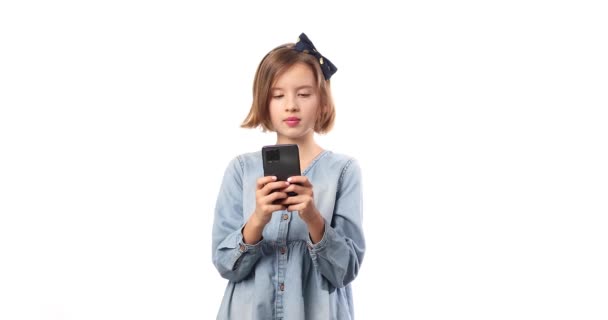 Smiling Little Girl Casual Denim Dress Hold Smartphone Using Mobile — Wideo stockowe