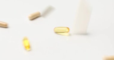 Falling of different pharmaceutical medicine pills, tablets and capsules, on white background, Medicine production, Heap of pills
