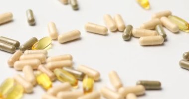 Rotation of different pharmaceutical medicine pills, tablets and capsules, on white background, Medicine concept, Heap of pills