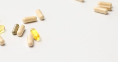 Rotation of different pharmaceutical medicine pills, tablets and capsules, on white background, Medicine concept, Heap of pills