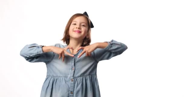Улыбка Маленькая Девочка Сделать Сердце Знак Руками Повседневной Джинсовой Платье — стоковое видео