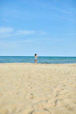 Happy, joyful little girl run on the beach , sea family vacation, Resort fun by the sea