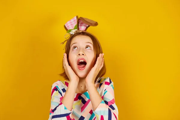 Happy Playful Teenager Girl Wearing Bunny Ears Bright Yellow Studio Stockfoto