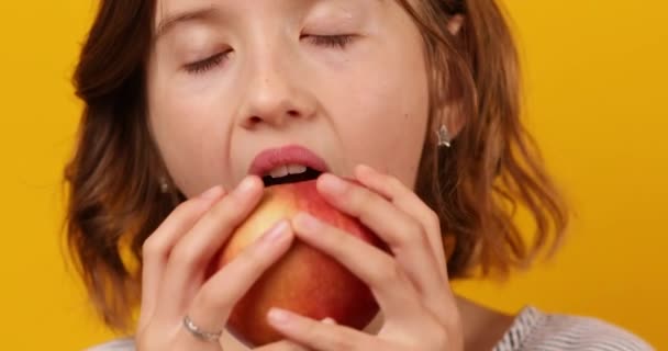 Frumoasă Fată Adolescentă Mănâncă Copii Mușcă Măr Proaspăt Roșu Izolat — Videoclip de stoc