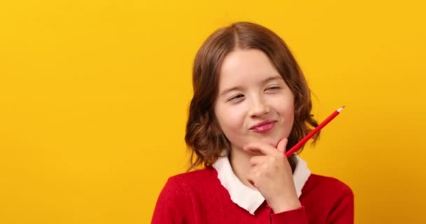 Sevimli Liseli Kız Elinde Kırmızı Kalemle Sarı Stüdyo Geçmişiyle Düşünceli — Stok video