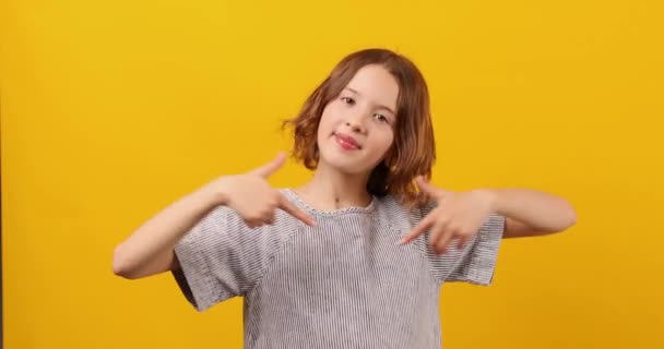 Portrait Happy Girl Teenage Pointing Finger Herself Yellow Studio Background — Stock Video