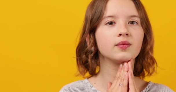 고요한 여학생은 노란색 배경에 그녀의 그녀의 손으로 신중하게 로열티 프리 스톡 비디오