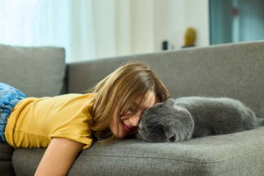 Yumuşak bir kanepede yatan bir kız İskoç kedisinin yanında başını dinlendiriyor. Oda aydınlık ve davetkar, sıcaklık ve sükunetle dolu ve birbirlerinin arkadaşlığından hoşlanıyorlar..
