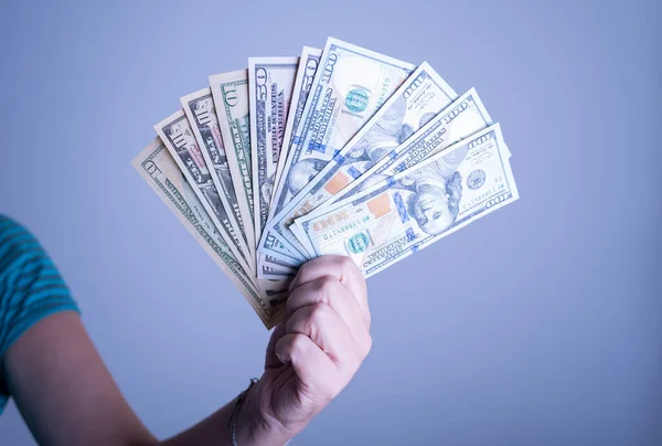 stock image Female hand holding dollar bills on transparent background. Concept of money and finance. Economic crisis