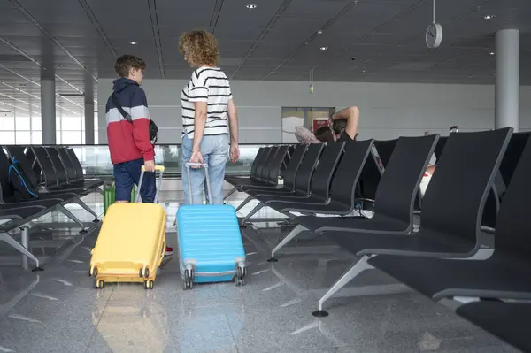 Woman Young Boy Suitcases Airport Waiting Area Royalty Free Stock Photos