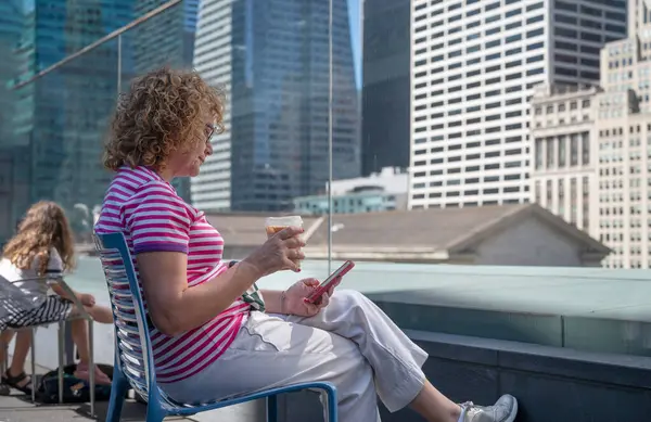 Woman Striped Shirt Using Smartphone While Enjoying Cold Drink Rooftop Royalty Free Stock Images