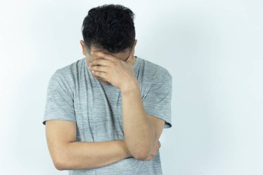 Portrait of Depressed Asian Man hiding his face with hands. Stressed, Hopeless, Frustration, Mental disorder, Broken heart and Psychological problems.
