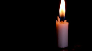 Time lapse Burning White Candle on the dark, flame of candle on black background