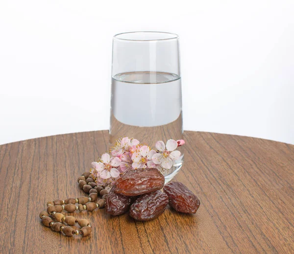 Suhoor, cam bir tasbih ağacında su ve kayısı çiçeği dalı