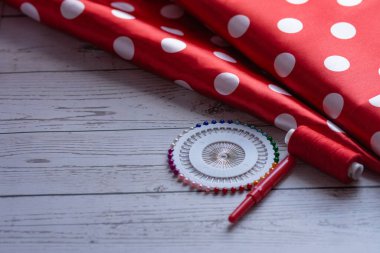 Puantiyeli kırmızı kumaş, dikiş iplikleri