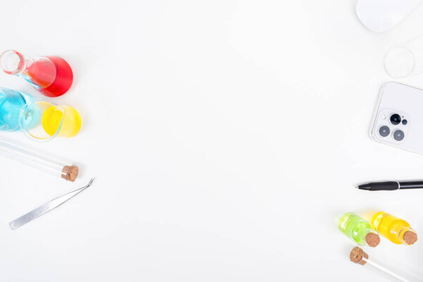 Top view table science lab chemistry flask with beakers, flasks, and test tubes filled with colorful liquids background