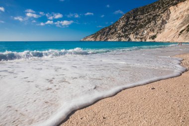 Mavi gökyüzüne karşı beyaz kum ve gök mavisi suyla Myrtos plajı - Kefalonia adası, İyon denizi, Yunanistan. Yatay.