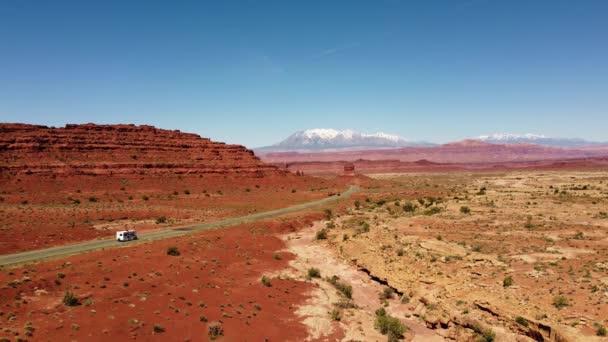 犹他的红色砂岩山和红色岩石 风景路 白雪覆盖的高山 孤独的车 蓝天4K分辨率 30Fps — 图库视频影像