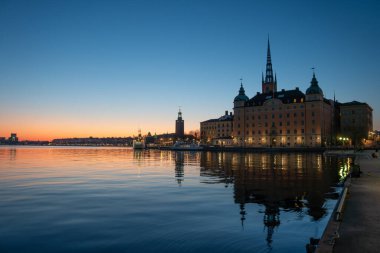 Yazın günbatımında Riddarholmen ve Kungsholmen ile Stockholm şehri manzarası.