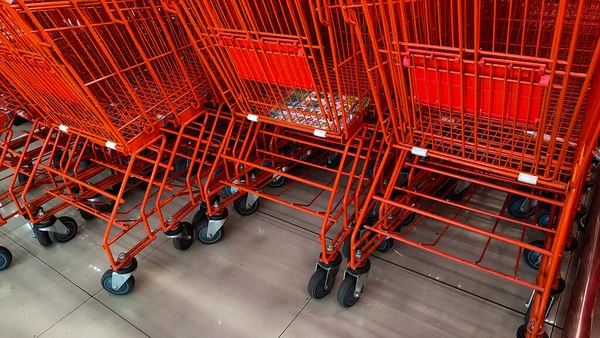 red shopping trolleys are lined up