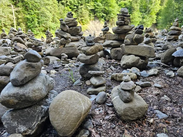 A tall stack of rocks, balancing precariously, forming a natural sculpture that captivates with its rugged beauty.