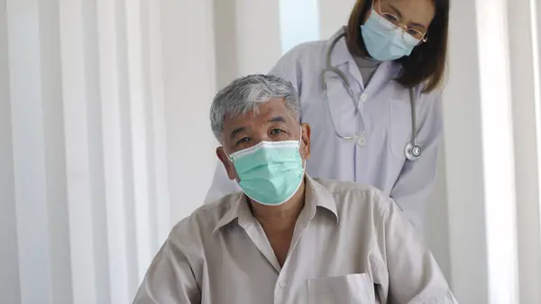 Asian Female Doctor Pushing Senior Adult Man Suffering Back Pain — Stock Photo, Image
