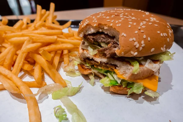 Zamknij Ugryzionego Podwójnego Cheeseburgera Tacy Świeżo Ugotowanymi Frytkami Wewnątrz Restauracji — Zdjęcie stockowe