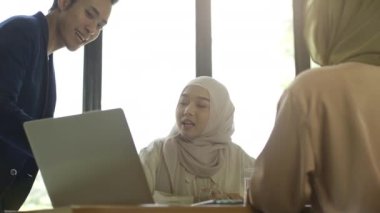 Hareketli ve hırslı bir Asyalı Müslüman girişimci grubu, küçük işletmeleri için büyüme stratejilerini tutkuyla tartışıyorlar.