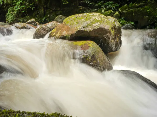 stock image Spun Waterfall in Sapun Village, Boklua, Nan province, is a hidden paradise where crystal-clear waters cascade over moss-covered rocks, surrounded by dense, vibrant jungle, offering a tranquil retreat