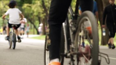 Parkta bisikletli genç adam ve çocuklar  