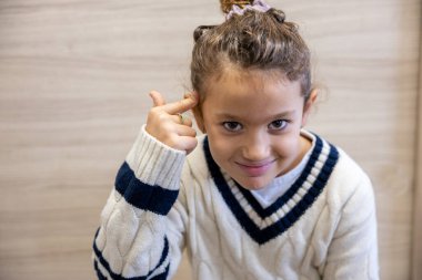 İçerde komik bir suratı olan küçük bir kızın portresi, boş bir alan.