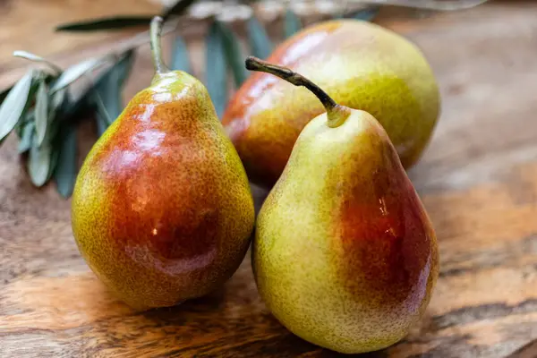 Close-up of three pears, red and green, fresh and tasty, very healthy.