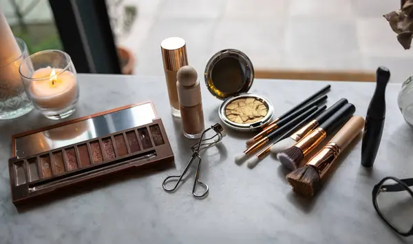 Detail of a table with beauty and make-up products at home.