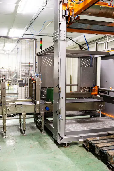 Automated conveyor system and bottling machinery used for efficient wine production in a contemporary winery setting.