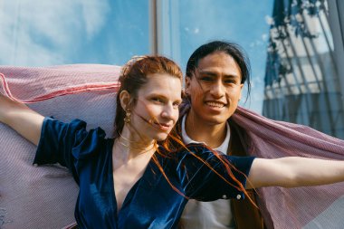 Gülümseyen yüzler ve paylaşılan bir eşarp, şehir keşiflerindeki iki arkadaşın sıcaklığını ve eğlencesini simgeliyor..