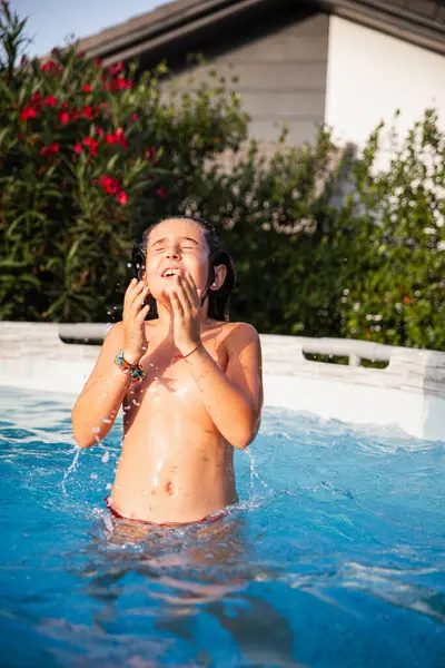 Joyful Young Girl Playing Swimming Pool Laughing Enjoying Water Splash — стоковое фото