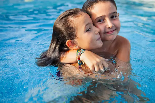 Two Young Sisters Embrace While Playing Swimming Pool Sunny Summer Imágenes De Stock Sin Royalties Gratis