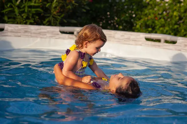 Two Young Sisters Share Tender Moment Swimming Pool Showcasing Bond Fotos De Stock Sin Royalties Gratis
