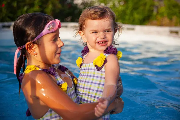 Two Happy Sisters Smiling Having Fun While Playing Together Swimming Imagen De Stock