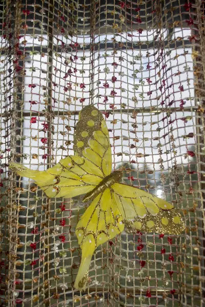 Yellow butterfly on the net flies up. The butterfly set is yellow on mesh tulle. Decor yellow butterfly