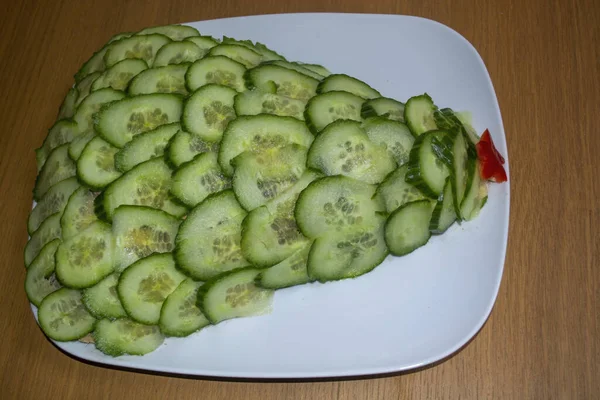 Salad New Year\'s green Christmas tree side view. Lettuce photo. Christmas tree salad. Green Christmas tree salad. New Year\'s salad with cucumbers and red sweet pepper